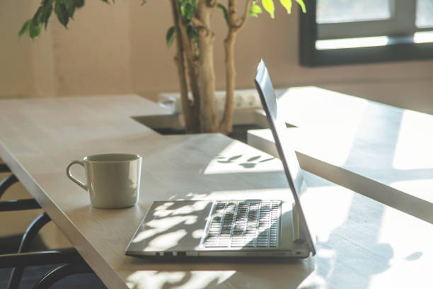 istock Modern workplace with laptop in the shadows. 1187397751