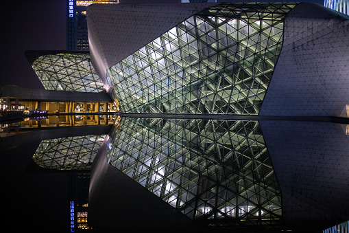 Guangzhou, China - October 12, 2019. Guangzhou Opera house in the evening and in the water its reflection