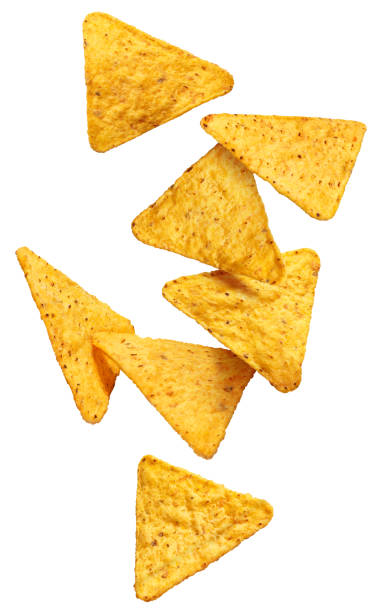 летающие чипсы начос на белом - nachos yellow white spice стоковые фото и изображения