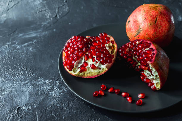 istock ripe red pomegranate and grain on a gray background 1187400282