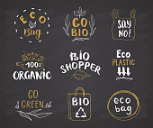 Eco and Bio Hand Drawn labels Set. Calligraphic Letterings with eco friendly sketch doodle elements. Vector illustration on chalkboard background