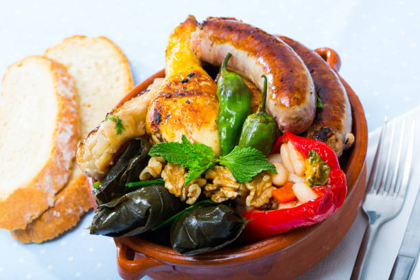 Bulgarian cuisine. Kapama Bulgarian cuisine. Kapama - mixed stewed plate from meat, sausages, stuffed cabbage, grape leaves and bell pepper kapama reserve stock pictures, royalty-free photos & images
