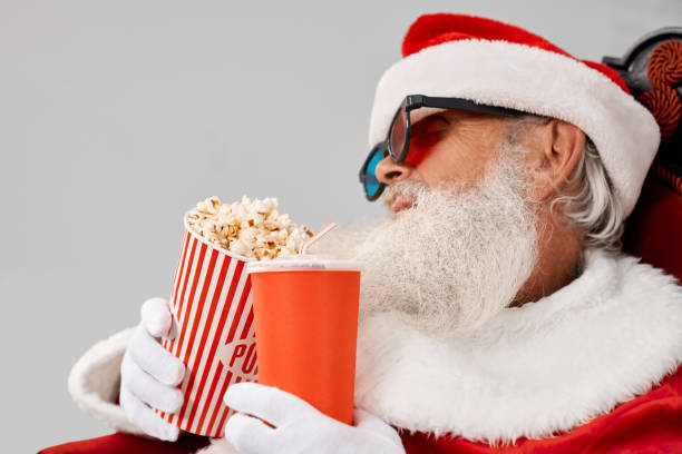istock Santa Claus sleeping in armchair with popcorn and cola 1187406767