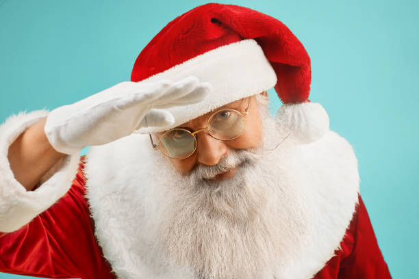 istock Traditional Santa Claus in glasses with grey beard in studio 1187406833