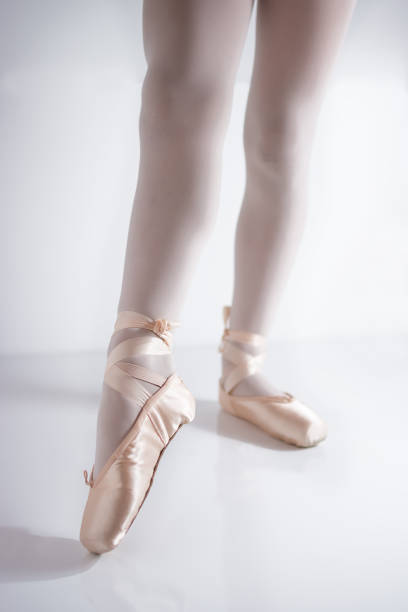 istock legs and feet with pink satin pointe shoes by a classical dancer posing 1187406857