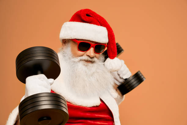 istock Cool Santa Claus with real beard workout with two dumbbells 1187406865