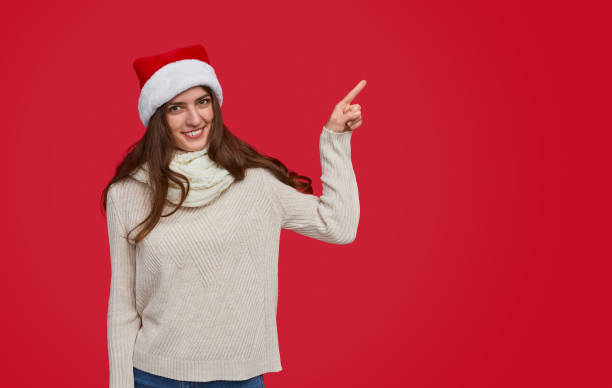 istock Woman pointing aside during Christmas celebration 1187407040