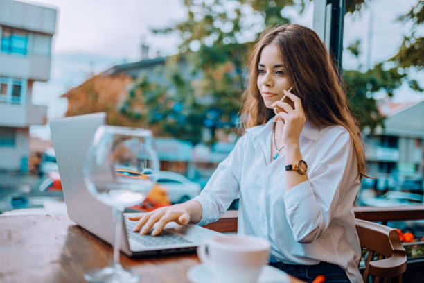 istock young woman receiving necessary information from customer by phone while working in cafe 1187407145
