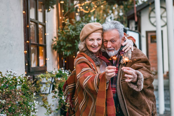 istock Happy senior couple holding sprinklers 1187407446