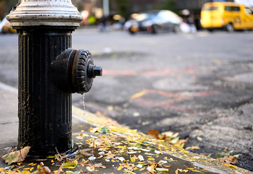 New York, NY, USA - November 13, 2019: A dripping fire hydrant faces Park Avenue on the upper east side of Manhattan on a very cold November morning.