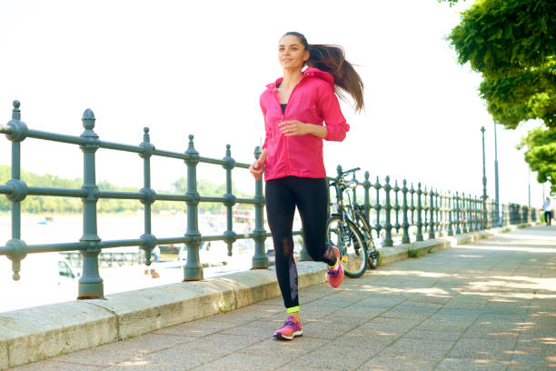 istock Young female running in the city 1187408399
