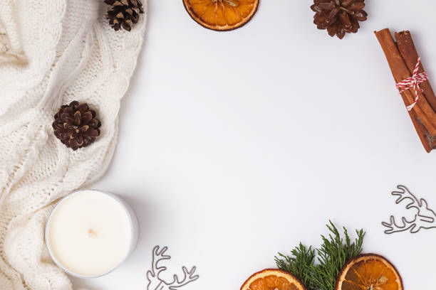 istock Creative winter frame with knitted sweater, pine cones, dry oranges and other objects 1187411407