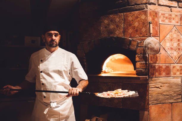 istock Pizza maker holding a peel in his hands 1187411979
