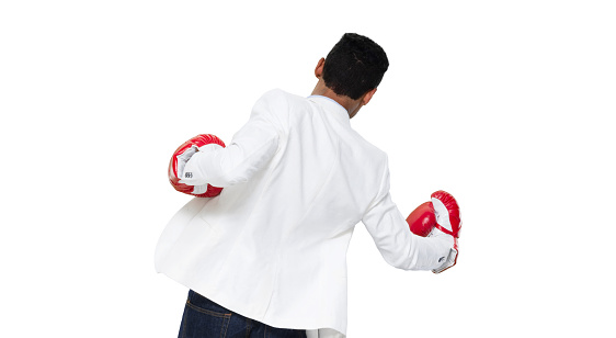 Front view / full length / one man only / one person / waist up / portrait of 20-29 years old adult handsome people black hair african ethnicity / african-american ethnicity male / young men standing wearing boxing glove / glove / jeans / pants / blazer - jacket / jacket / button down shirt / shirt and boxing who is punching / fighting / sport