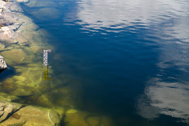 Water depth marker in a reservoir. Environment and sustainability concept. Photograph with copy space.