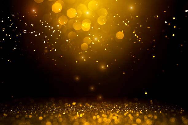 istock Golden abstract bokeh on black background. 1187419009