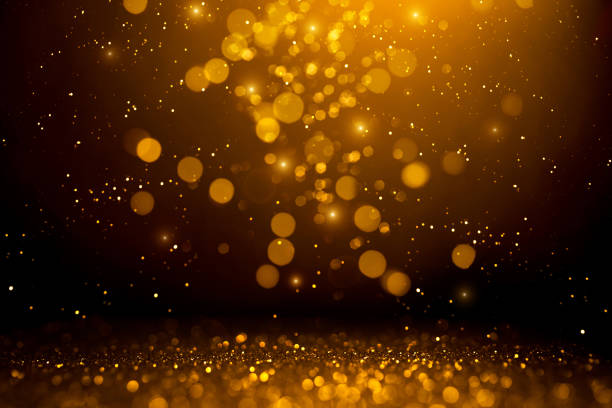 istock Golden abstract bokeh on black background. 1187419010