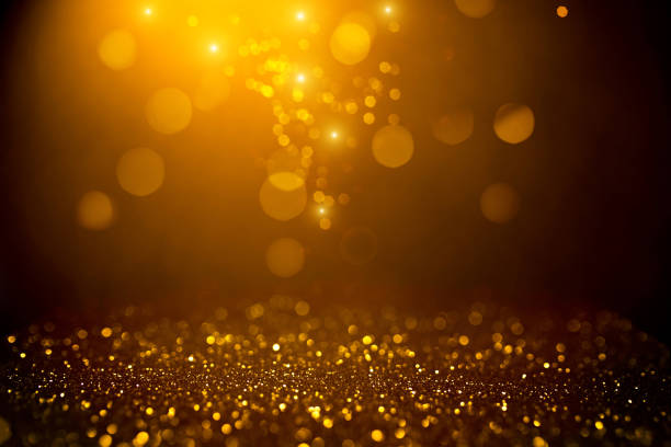 istock Golden abstract bokeh on black background. 1187419011