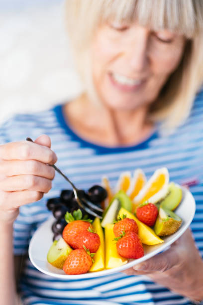 istock Attractive senior woman with fruit lunch 1187419873