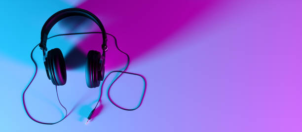 istock headphones on a black background close-up in neon light 1187421343