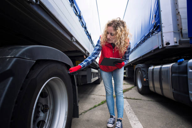 Checking tires. Truck transportation. Truck driver checking vehicle tires and inspecting truck before ride. Transportation services. truck mode of transport road transportation stock pictures, royalty-free photos & images