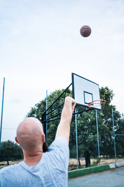 istock Young basketball player shooting a triple 1187422808