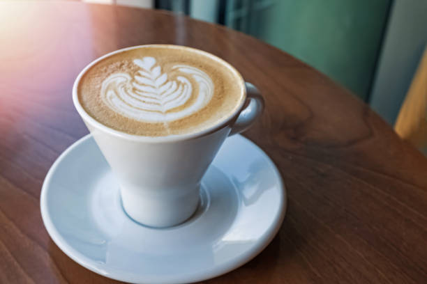 istock Cappuccino in a big white mug standing on the wooden table 1187425362