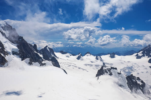 istock Snowy mountain peaks against the blue sky. 1187425404