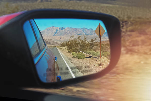 istock Road reflecting in the sideview mirror of a car 1187425476