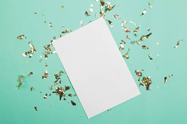 istock Blank paper with place for text on turquoise background with golden confetti 1187426085