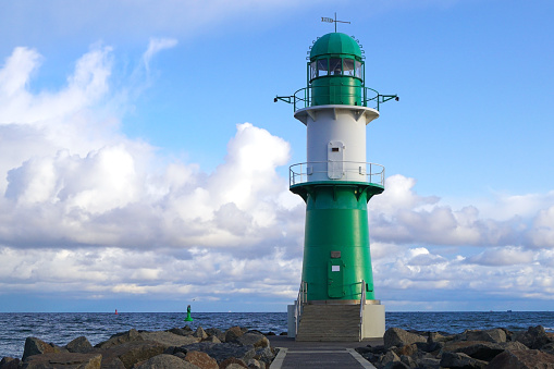 The green lighthouse on the pier at the harbour entrance of Rostock