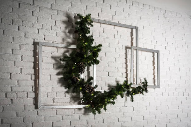 istock Winter home decor. Christmas tree in loft interior against brick wall. 1187427564