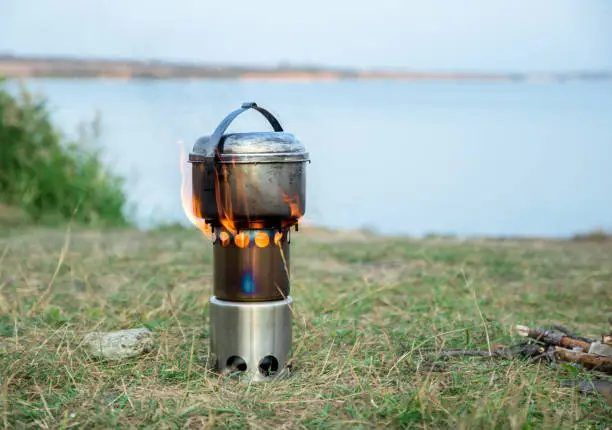hiking woodstove and kettle, lake on the background