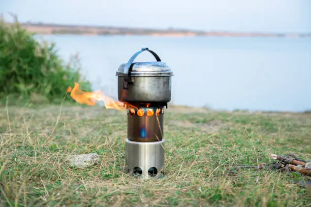 hiking woodstove and kettle, lake on the background