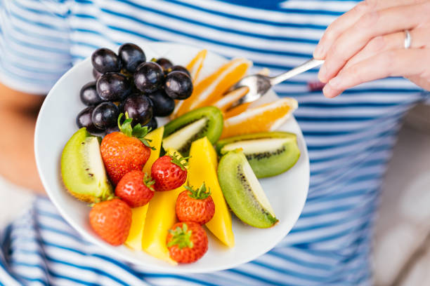 Attractive senior woman with fruit lunch