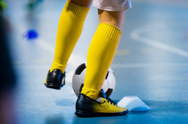 Futsal soccer training. Single young futsal player with ball on training. Close up of legs of futsal footballer. Indoor european football practice unit Futsal soccer training. Single young futsal player with ball on training. Close up of legs of futsal footballer. Indoor european football practice unit football socks stock pictures, royalty-free photos & images