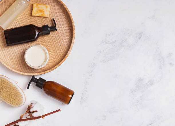 istock Natural cosmetics in small bottles on the white marble table 1187433912