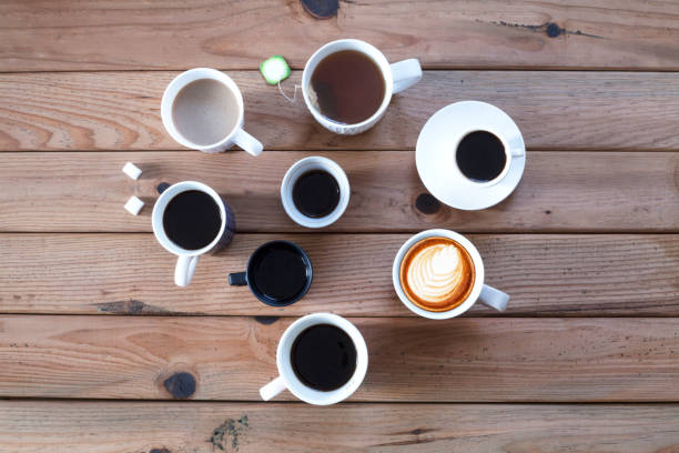 istock many coffee cups over wooden cafe table 1187436722