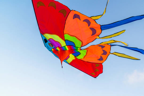 istock colorful kite flying in the blue sky 1187436946