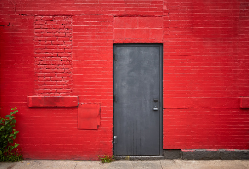 Steel door in an old red brick wall.
