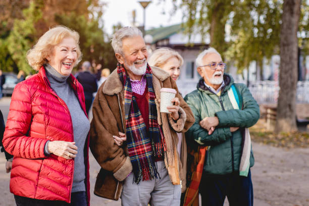 istock Four happy seniors in the park 1187442387