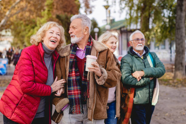 istock Four happy seniors in the park 1187442817