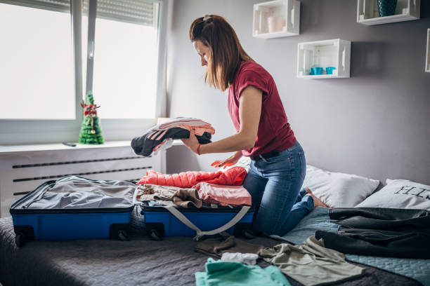 istock Woman is packing clothes 1187445140
