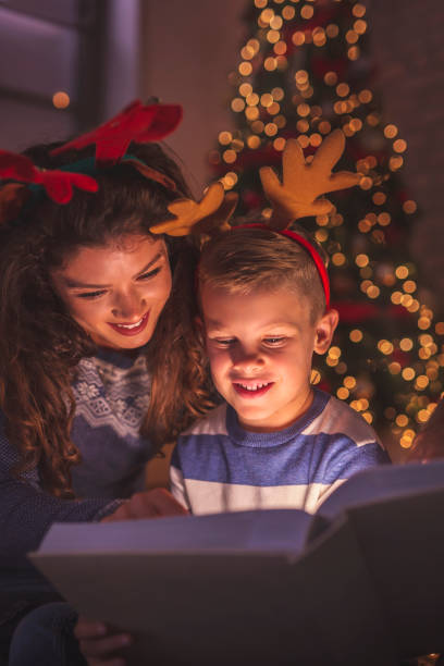 istock Mother and son reading a fairytale for Christmas 1187446786