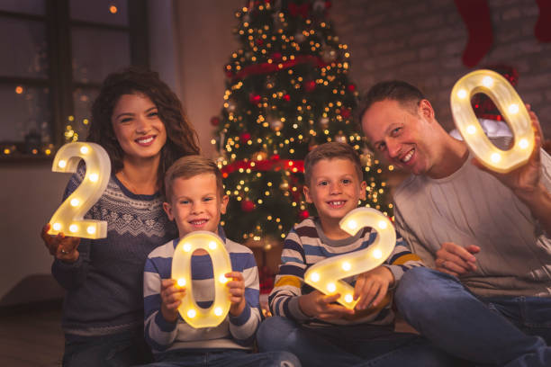 istock Parents and kids holding illuminative numbers 2020 1187448540