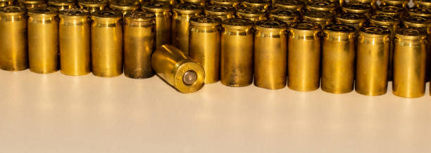 istock Neat rows of used bullets with one knocked down 1187449032
