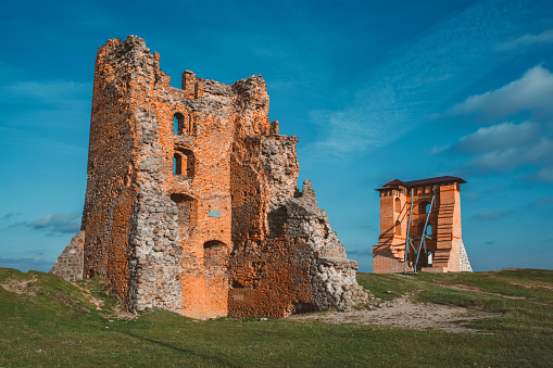 Ruins of Towers and Mindovg Castle on blue sky background in Novogrudok city, Belarus.