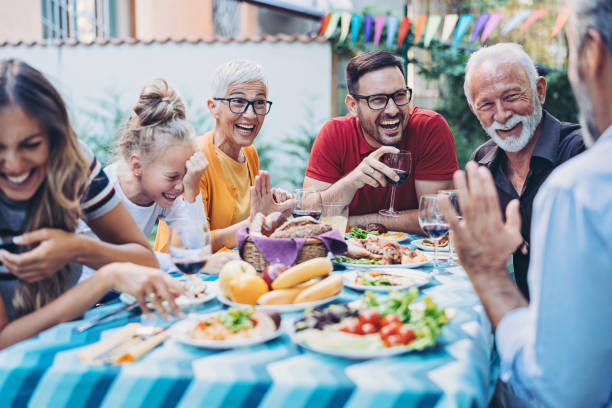 istock Extended family eating, drinking and joking 1187451198