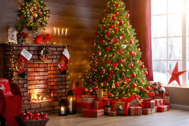 interior christmas. magic glowing tree, fireplace and gifts