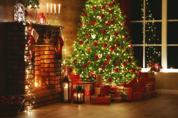 istock interior christmas. magic glowing tree, fireplace, gifts in  dark 1187452417